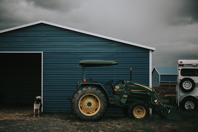 Person taking a picture of a green tractor