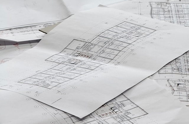 Architectural plans spread out on a surface.